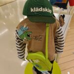 kladskap（クレードスコープ）のキッズコーデ例。ロゴ入りキャップと明るいカラーのアイテムを合わせた着こなし。